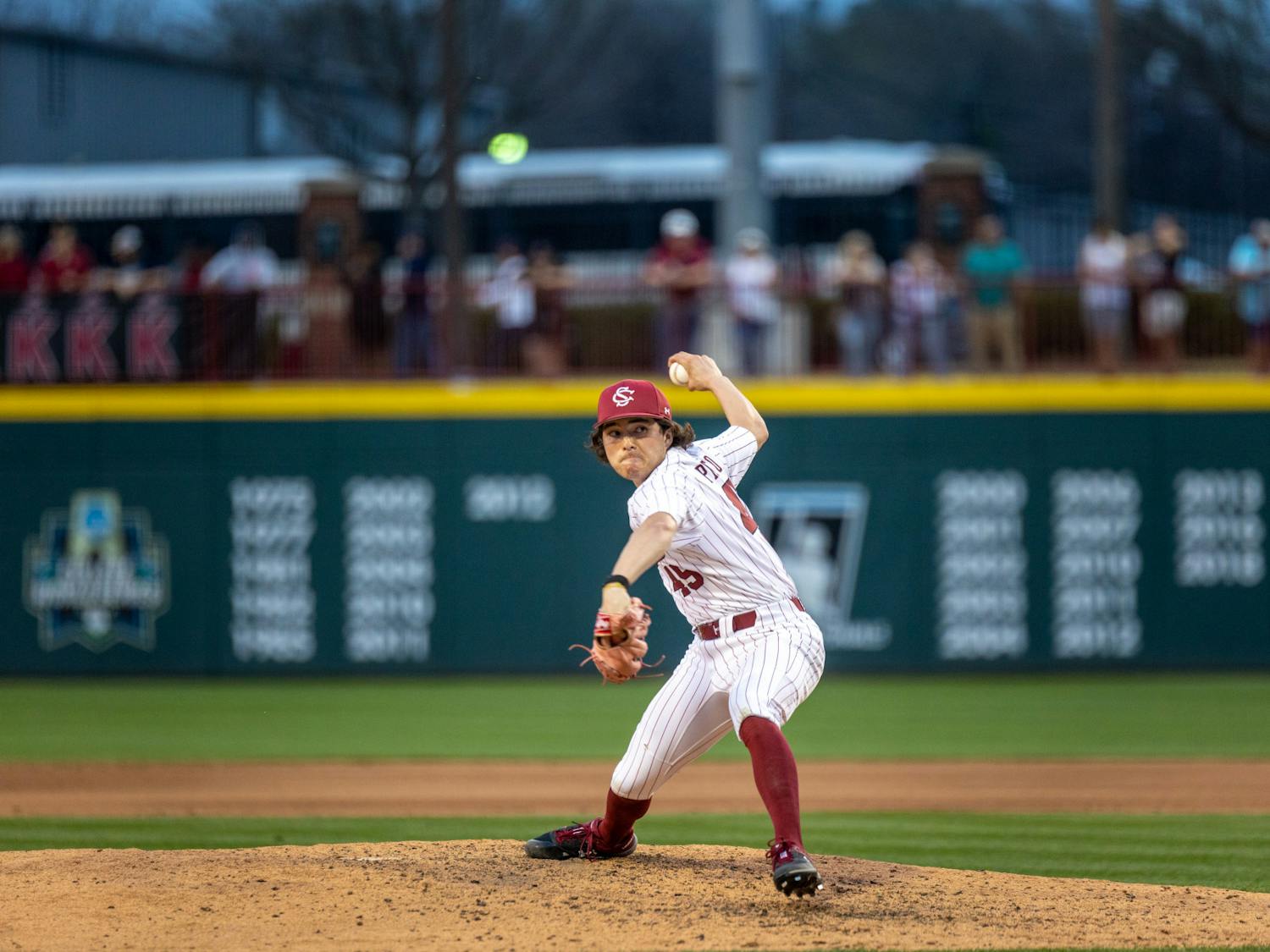 Throwing from the top of the mound, fifth-year pitcher Nick Proctor winds up to through the ball for the Gamecocks' game against the Fighting Quakers at Founders Park on Feb. 24, 2023. South Carolina made seven total home runs within the nine innings, finishing with a score of 7-4.