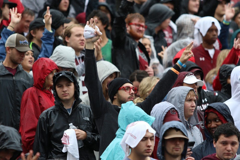 A student holds up three fingers to show his support for freshman quarterback Ryan Hilinski.