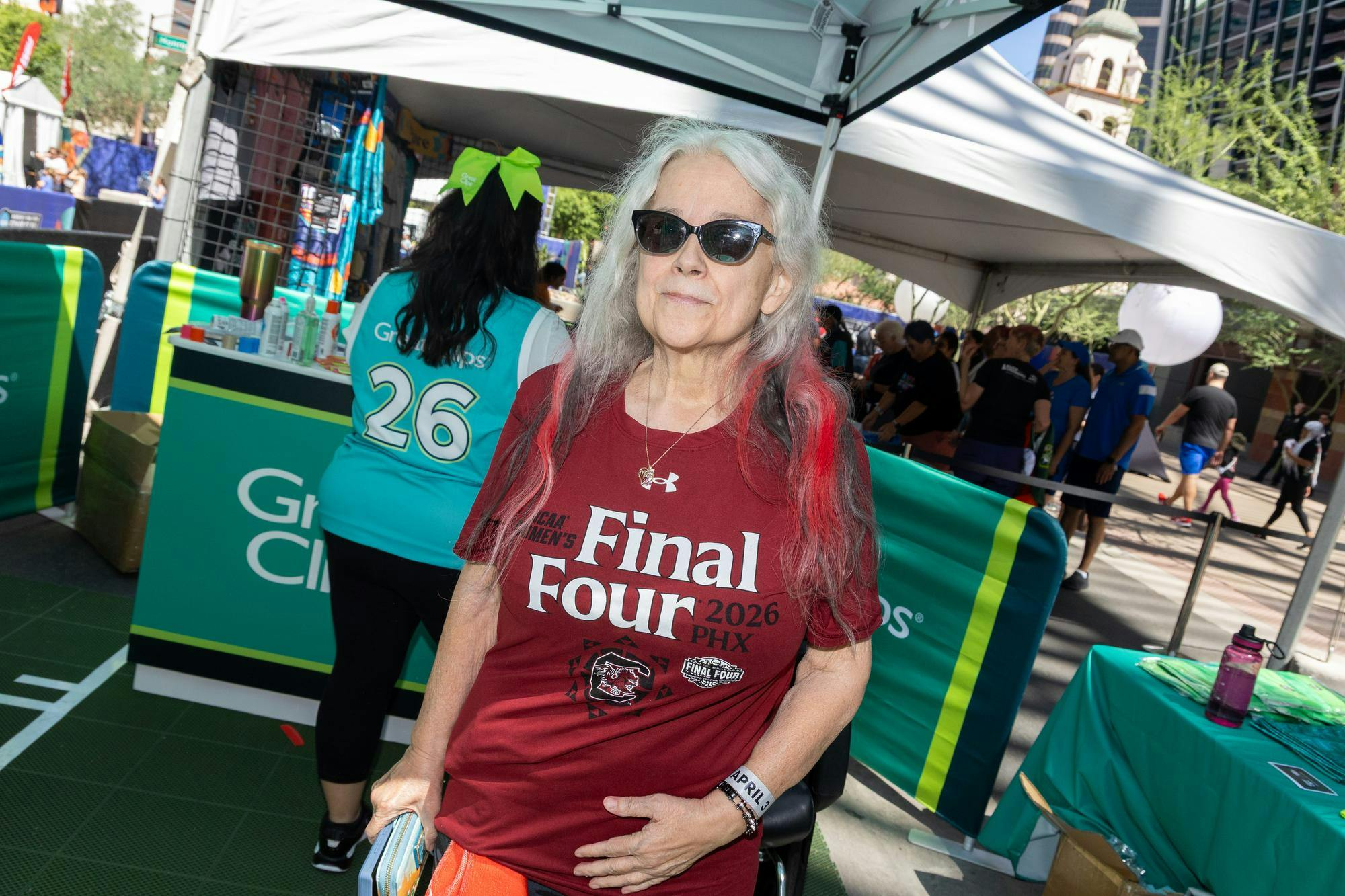 Gamecock alumna Margaret Jennings shows off her black and red dyed hair at the Great Clips stand at Tourney Town at the Final Four in Phoenix, Arizona, on April 3, 2026. Jennings attended South Carolina in the '70s as a biology student and worked at the university for a long time.