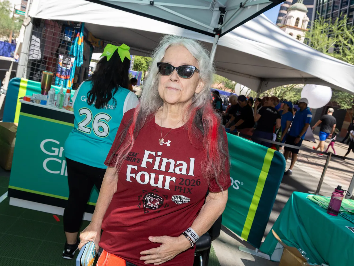 Gamecock alumna Margaret Jennings shows off her black and red dyed hair at the Great Clips stand at Tourney Town at the Final Four in Phoenix, Arizona, on April 3, 2026. Jennings attended South Carolina in the '70s as a biology student and worked at the university for a long time.