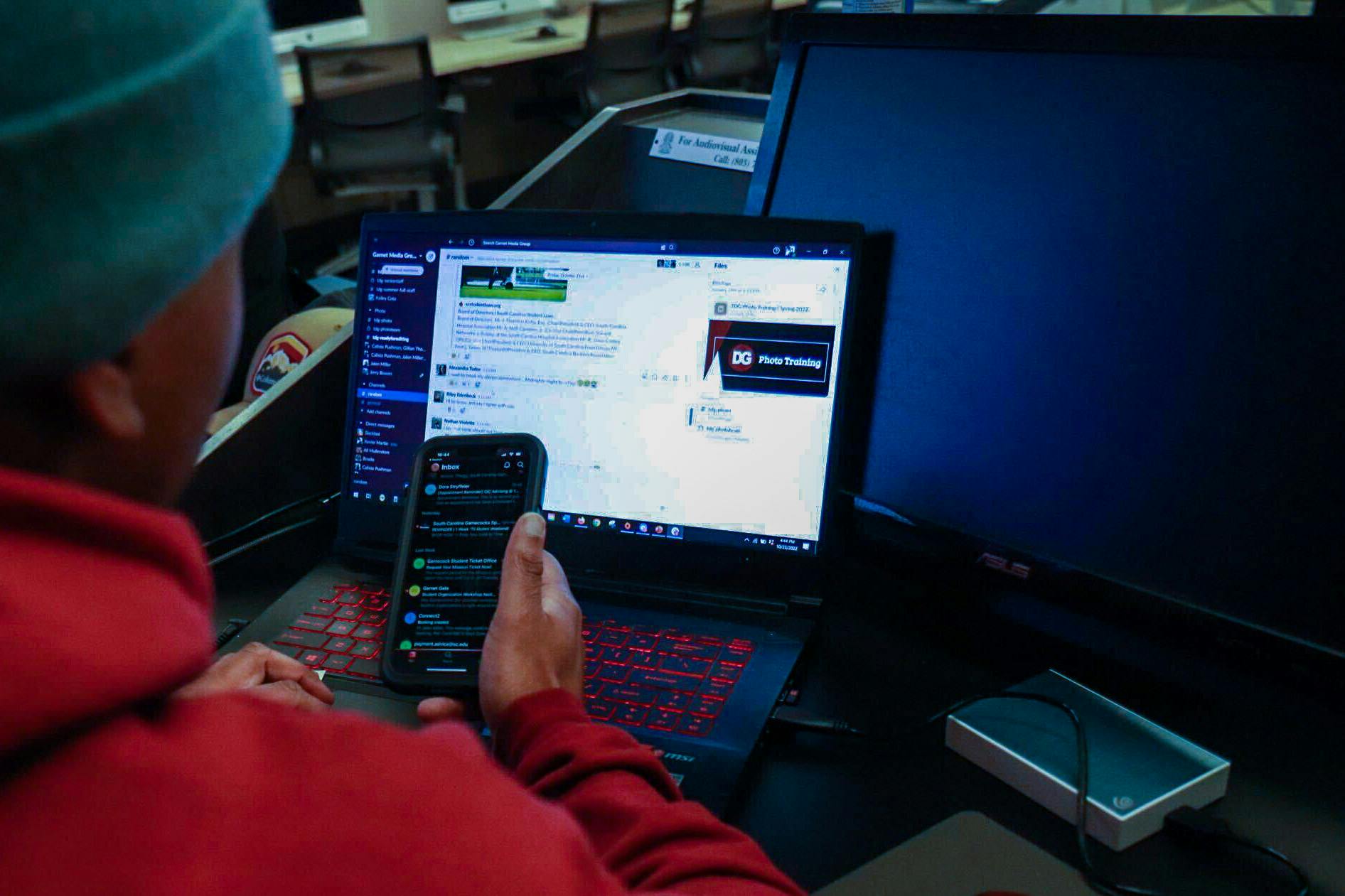 PHOTO ILLUSTRATION: A student checks their email on an iPhone while going through personal messages on their computer on Oct. 23, 2022. Columnist Dylan McCants said that students have become too reliant on technology.&nbsp;