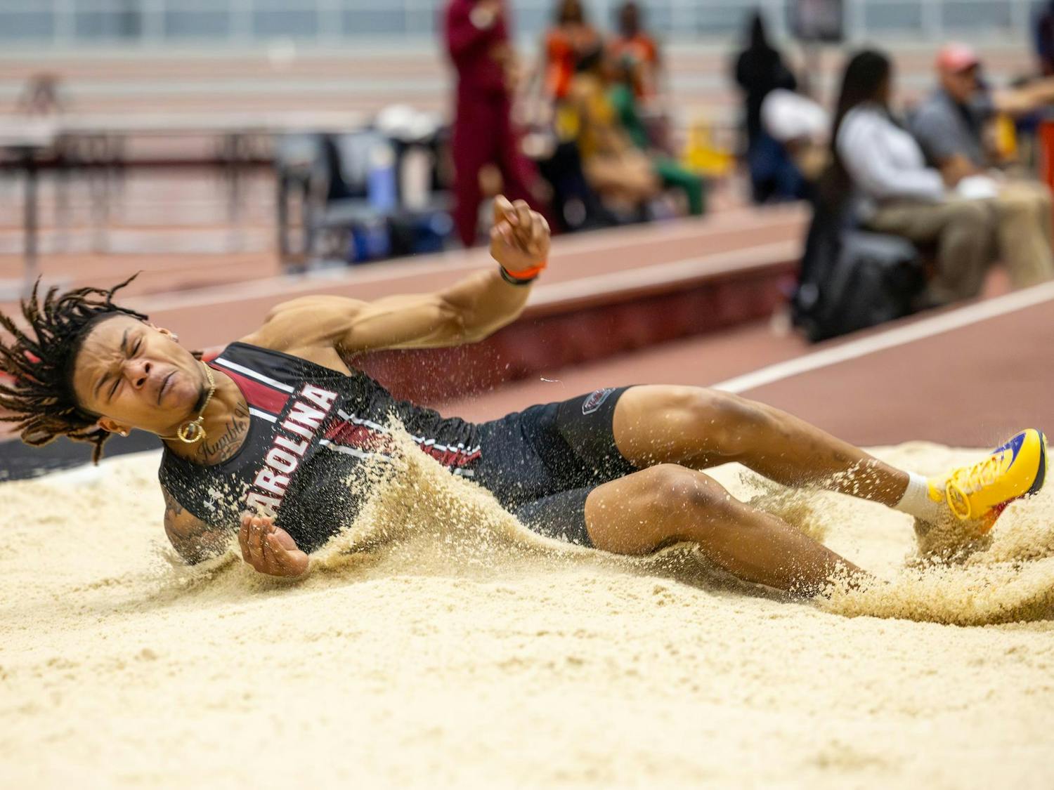 Junior jumper Spencer Eison lands in the sand during the men's triple jump at the Carolina Classic track and field meet on Feb. 6, 2026. Eison finished in fifth with a distance of 14.44 meters.