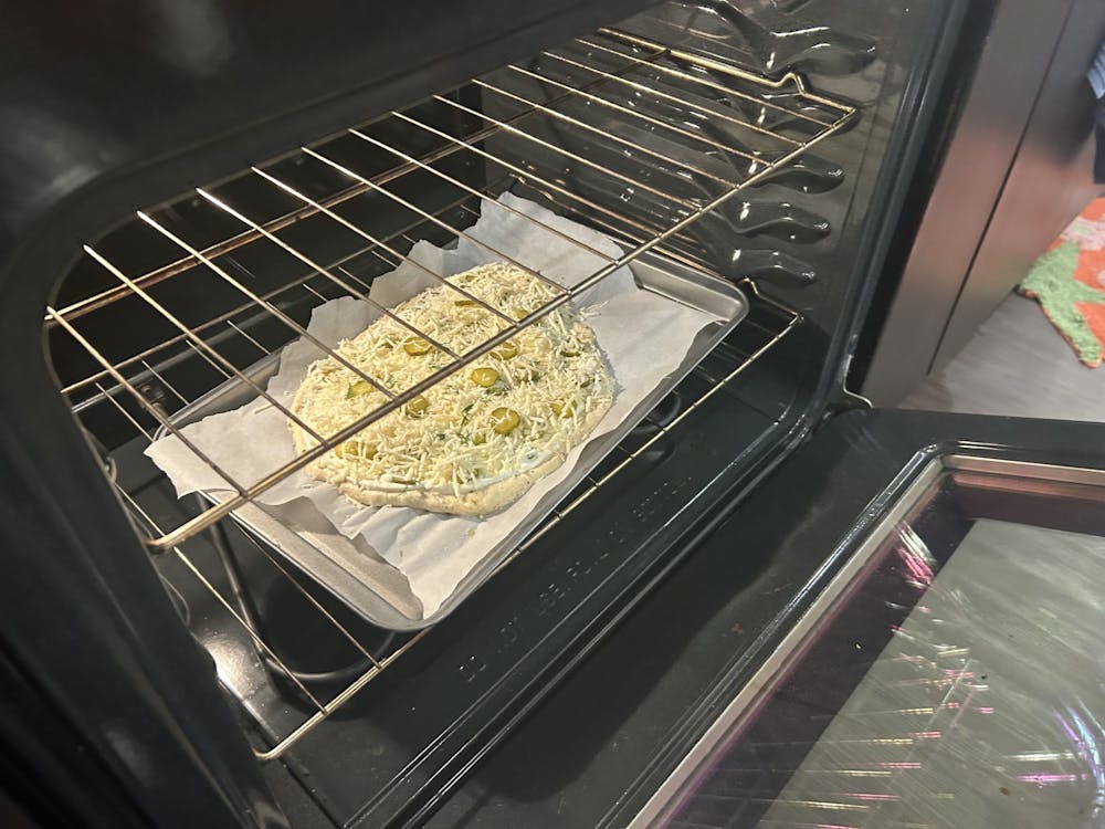 <p>A dill pickle pizza goes goes into the oven before being cooked for 20 minutes on Oct. 29, 2023. Arts and culture writer Jamie Alatzas shares a recipe for the new South Carolina State Fair favorite.</p>