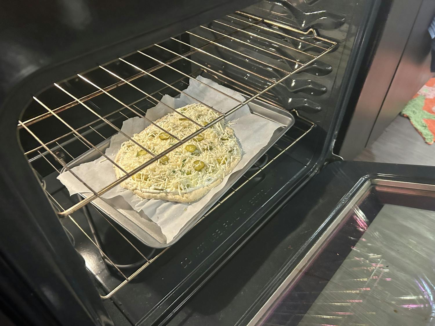 A dill pickle pizza goes goes into the oven before being cooked for 20 minutes on Oct. 29, 2023. Arts and culture writer Jamie Alatzas shares a recipe for the new South Carolina State Fair favorite.