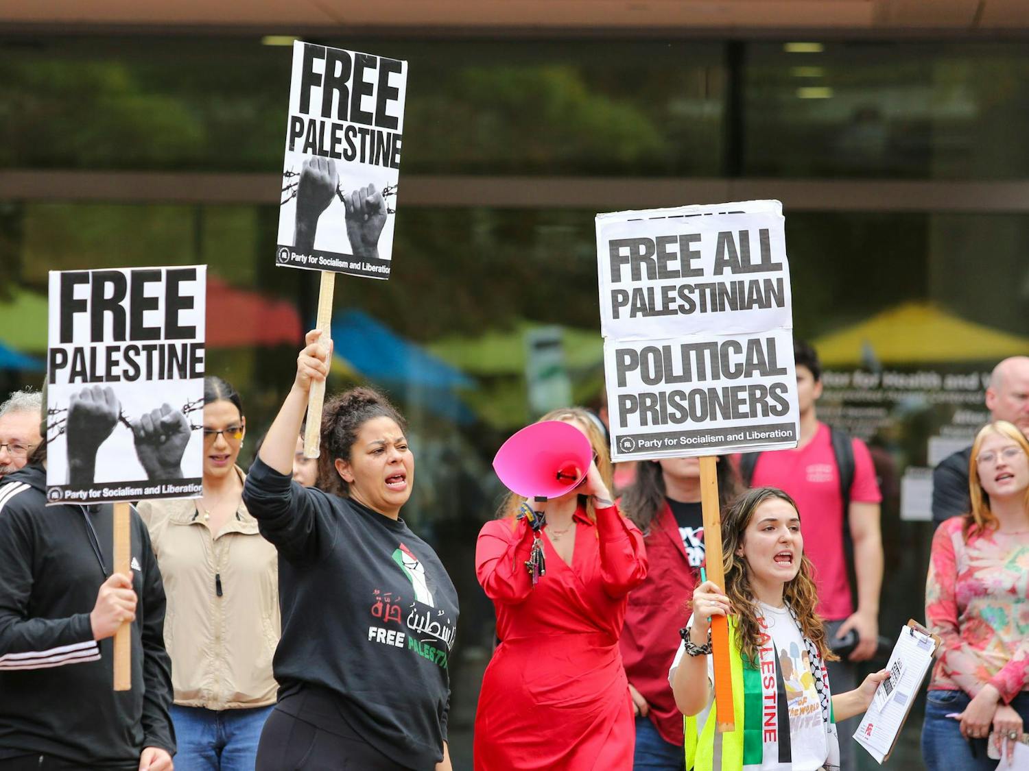 Attendees hold up signs of support during a walkout for Palestine on the Russell House Patio on Nov. 9, 2023. Participants at the walkout chanted "Free Palestine" throughout the afternoon.