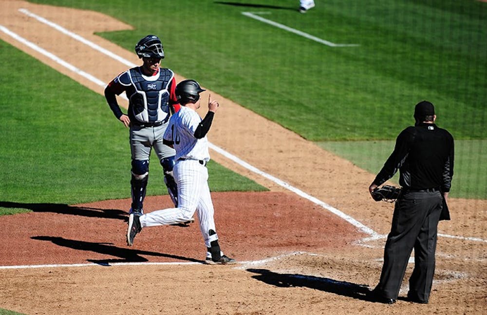 Sophomore catcher Colin Burgess scores against Dayton. South Carolina swept the three-game series against the Flyers to open the 2021 season.