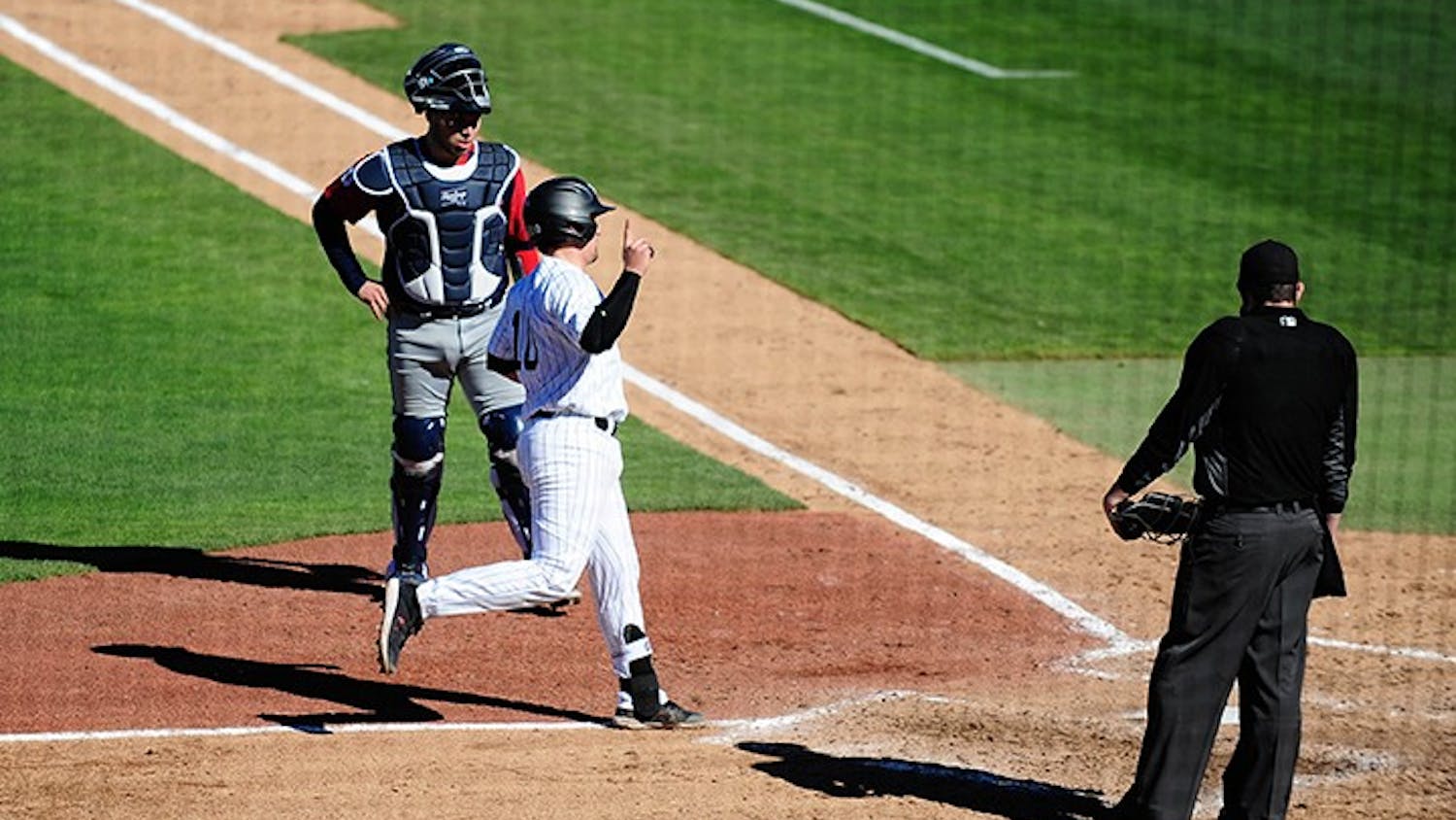 Sophomore catcher Colin Burgess scores against Dayton. South Carolina swept the three-game series against the Flyers to open the 2021 season.
