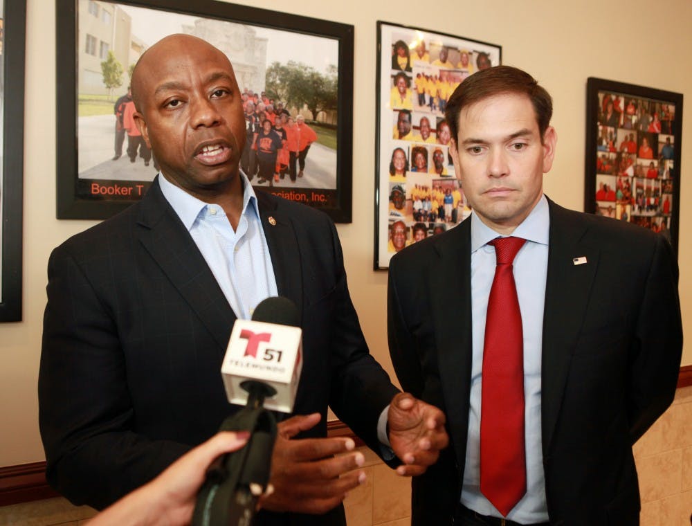 Senators Tim Scott, left, and Marco Rubio talk to the media after the meeting with religious leaders at Jackson Soul Food on Wednesday Nov. 2, 2016 in Miami. (Roberto Koltun/Miami Herald/TNS) 