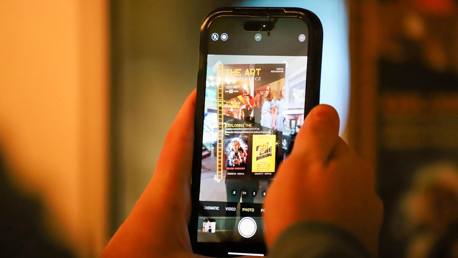 A person uses a smartphone to take a photo of a poster outside of the Nickelodeon Theatre at 1607 Main St. in Columbia, SC on Jan. 17, 2024. The poster advertises the double feature of "Blade Runner" and "The Shining."