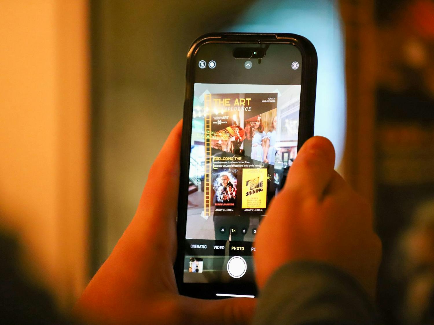 A person uses a smartphone to take a photo of a poster outside of the Nickelodeon Theatre at 1607 Main St. in Columbia, SC on Jan. 17, 2024. The poster advertises the double feature of "Blade Runner" and "The Shining."