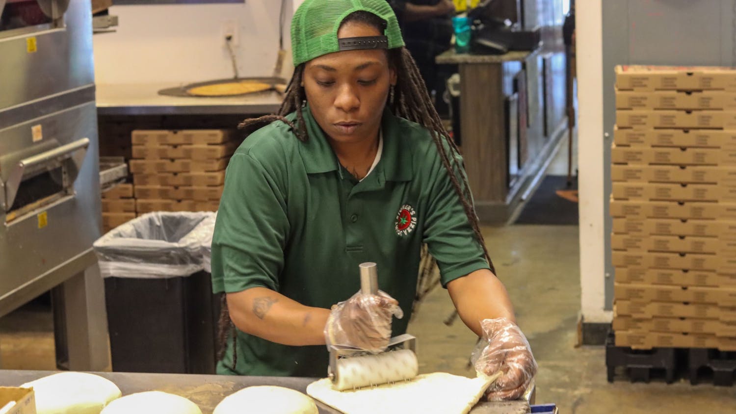 Quinotrese Johnson, a general manager at Stoner’s pizza, rolls dough on March 25, 2022. Johnson said she believes strongly in providing assistance to those in need and uses her position to help out in any way she can.