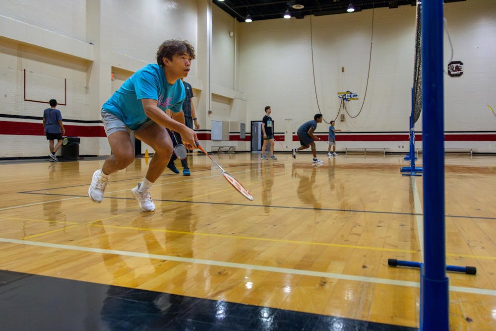 <p>Fourth-year public health student Dylan Dang prepares to return the birdie during club badminton practice on Sept. 11, 2024. Club Badminton practices on Wednesday and Thursday Nights at Blatt Public Education Center.</p>