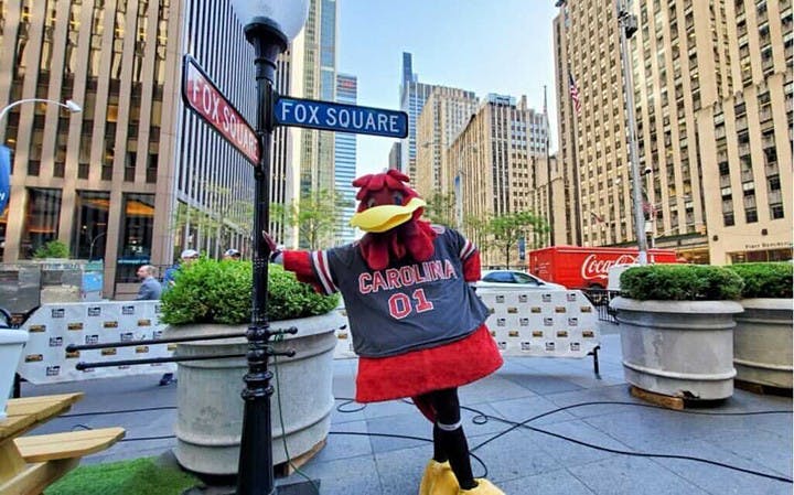 Cocky leaning up against the Fox Square sign outside of the Fox Network studios.