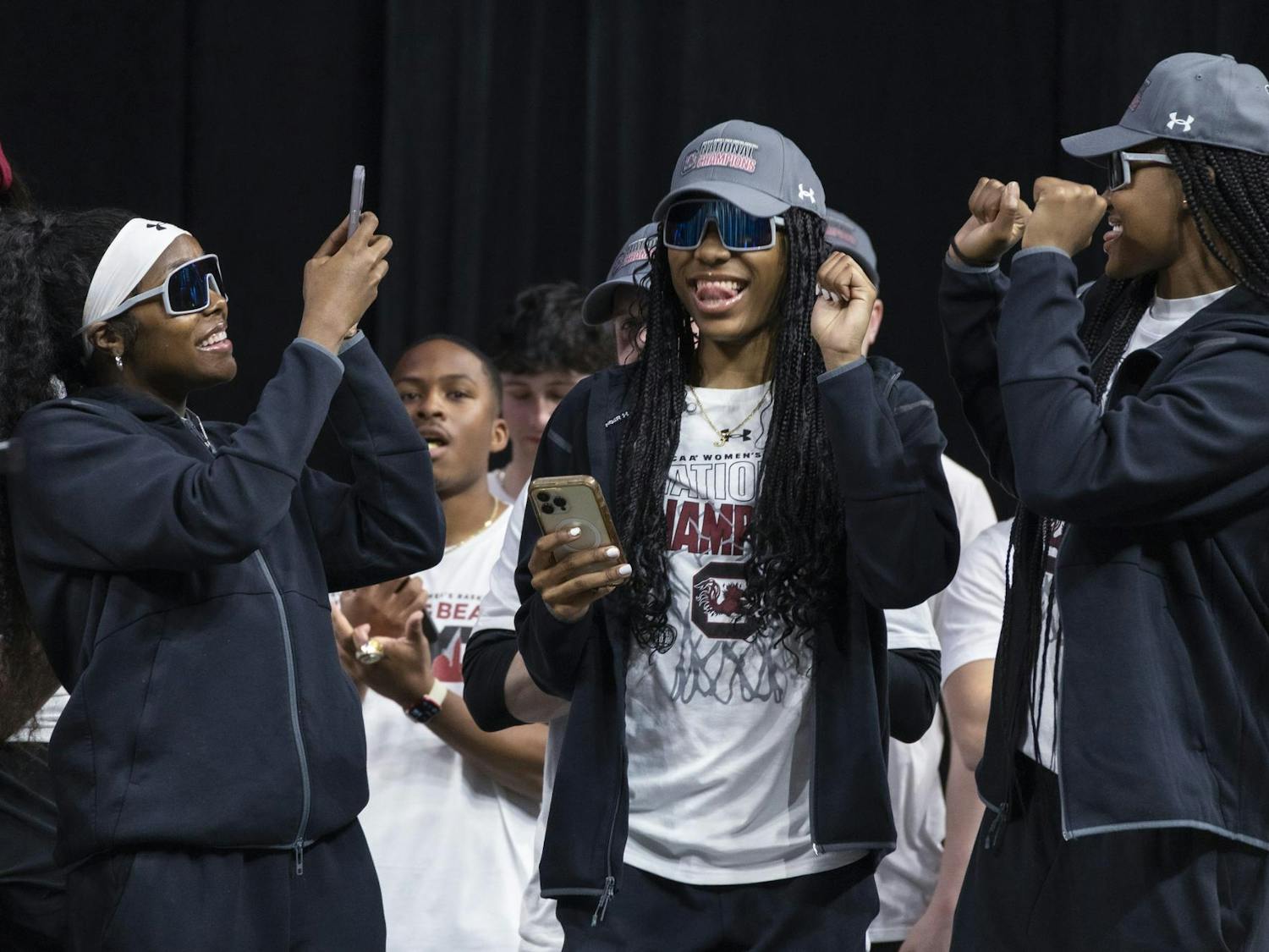 Sophomore guard Raven Johnson takes a photo of junior guard Bree Hall on stage at Colonial Life Arena on April 8, 2024. The Gamecock women's basketball team was welcomed home by fans in a celebration with remarks from athletic director Ray Tanner and head coach Dawn Staley.