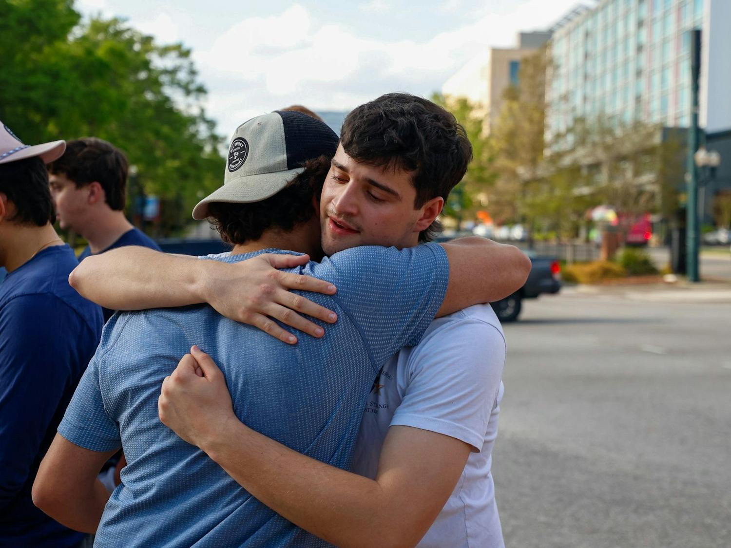 Two students hug outside the memorial for Nathaniel "Nate" Baker at Strom Thurmond Wellness and Fitness Center on April 3, 2025. Dozens of students showed up to the memorial in honor of Baker, who was the victim of a hit-and-run at the intersection of Assembly and Blossom streets.