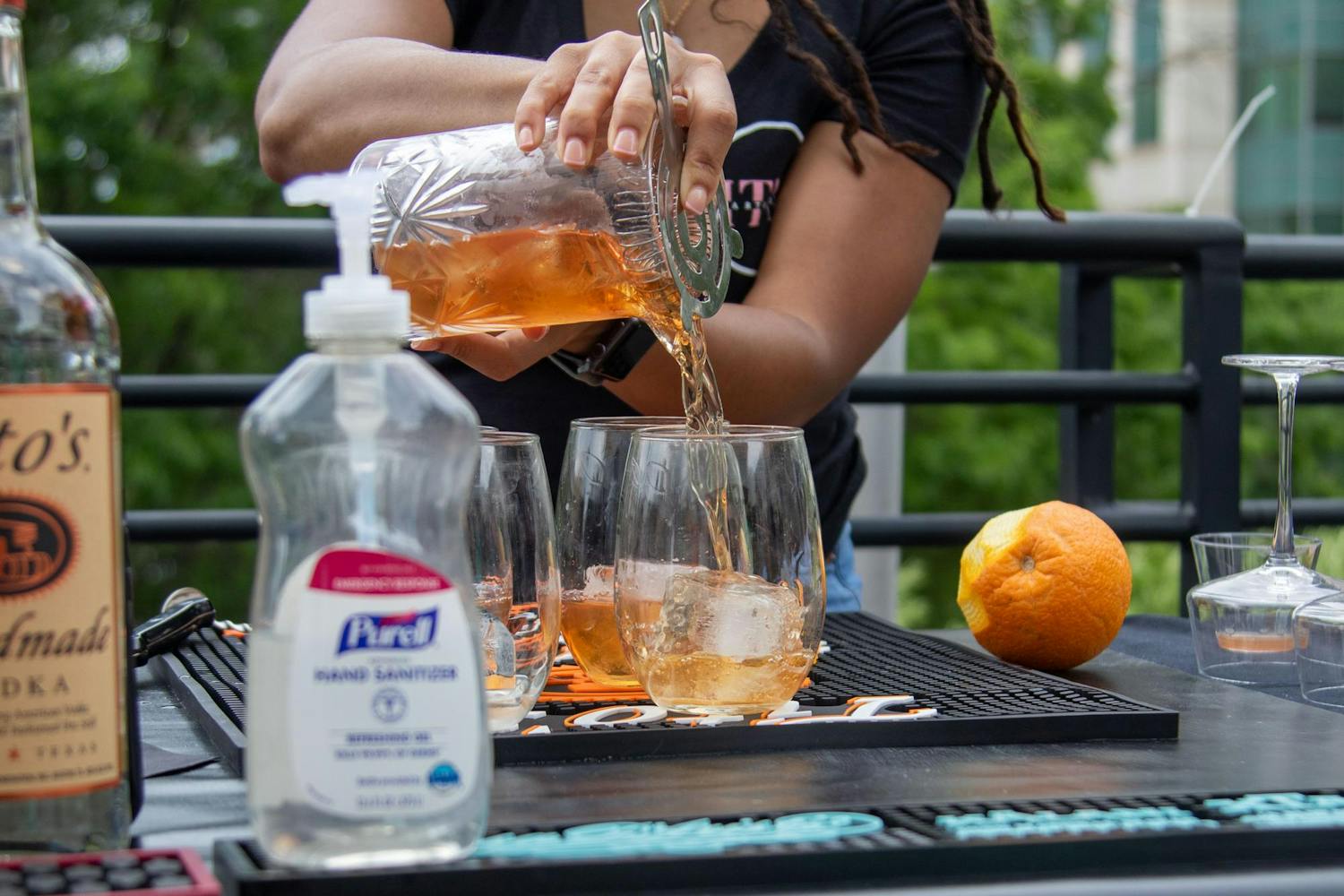 Crystal Stevens, a bartender at ITM Bartending, pours an Old Fashioned during the initial rounds of the Capital City Cocktail Competition on June 9, 2024. The event, hosted by Bubblee Mixologist, highlighted Columbia's vibrant creative community.
