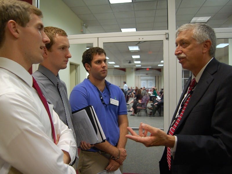 SG leaders Ryan Bailey, Kenny Tracy and Erik Singleton speak with Assistant Chief of Police Leslie Wiser about crime in Five Points at Tuesday’s City Council meeting.
