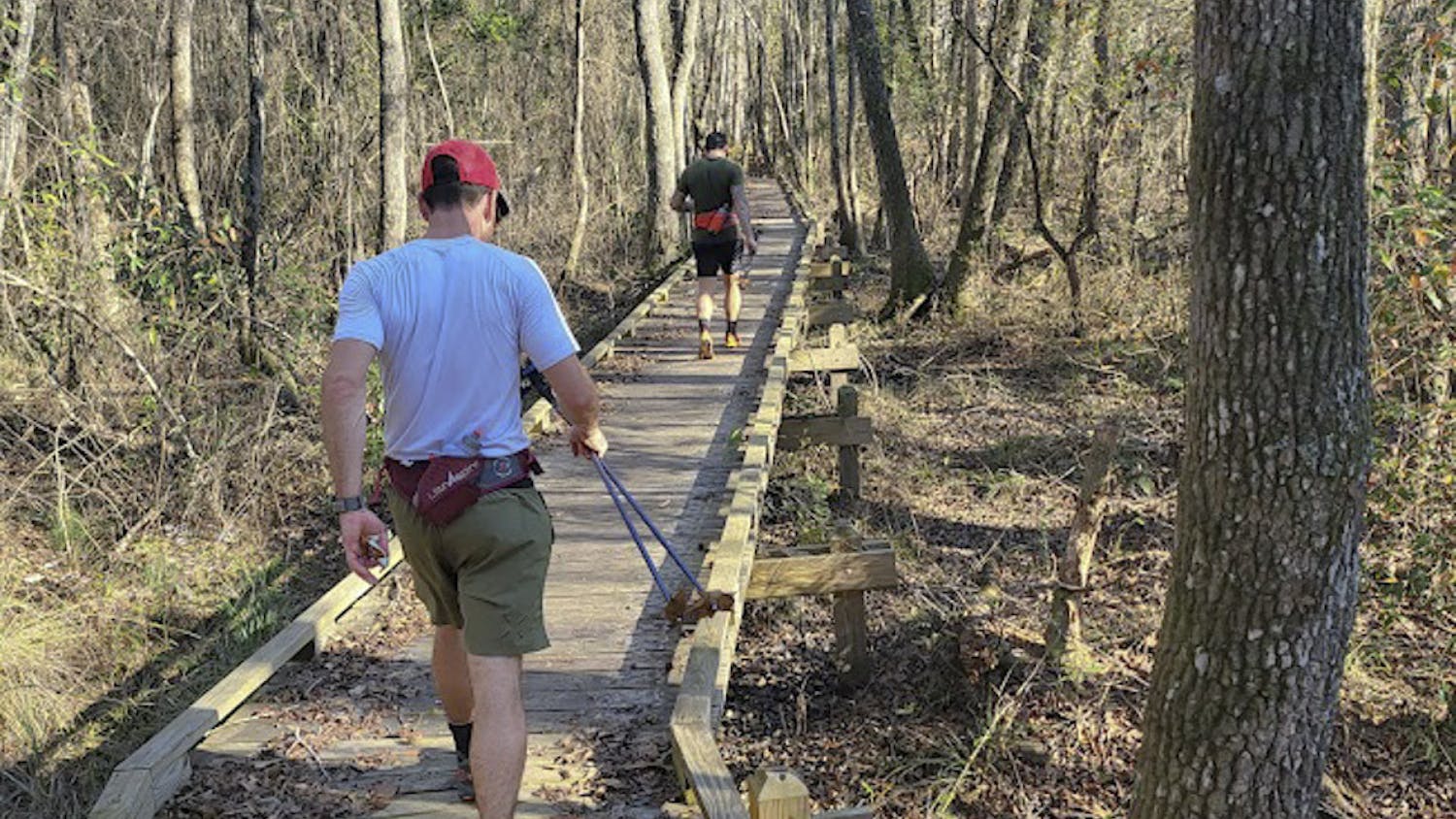 Nathan Frantz (left) and Sean Clayton (right) run along a boardwalk on the Palmetto Trail. The duo ran the 350-mile trail in a record 10 days, 11 hours and 24 minutes over winter break.&nbsp;