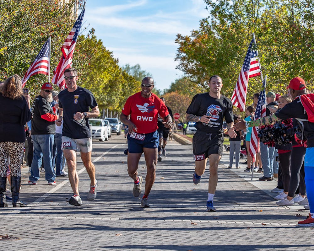 <p>Lieutenant Colonel Daniel Hayes (on left), Command Sergeant Major Philson Tavernier, (center), and Staff Sergeant Juan Vallellanes (on right), from U.S. Army Training Center Fort Jackson, run to the finish line together during the USC Veterans 5K on Nov. 13, 2022. The annual 5K honors veterans, service members, and their families. The 5K has raised over $50,000 for The Big Red Barn Retreat, which offers therapeutic programs and services for veterans, active duty service members, and first responders.</p>