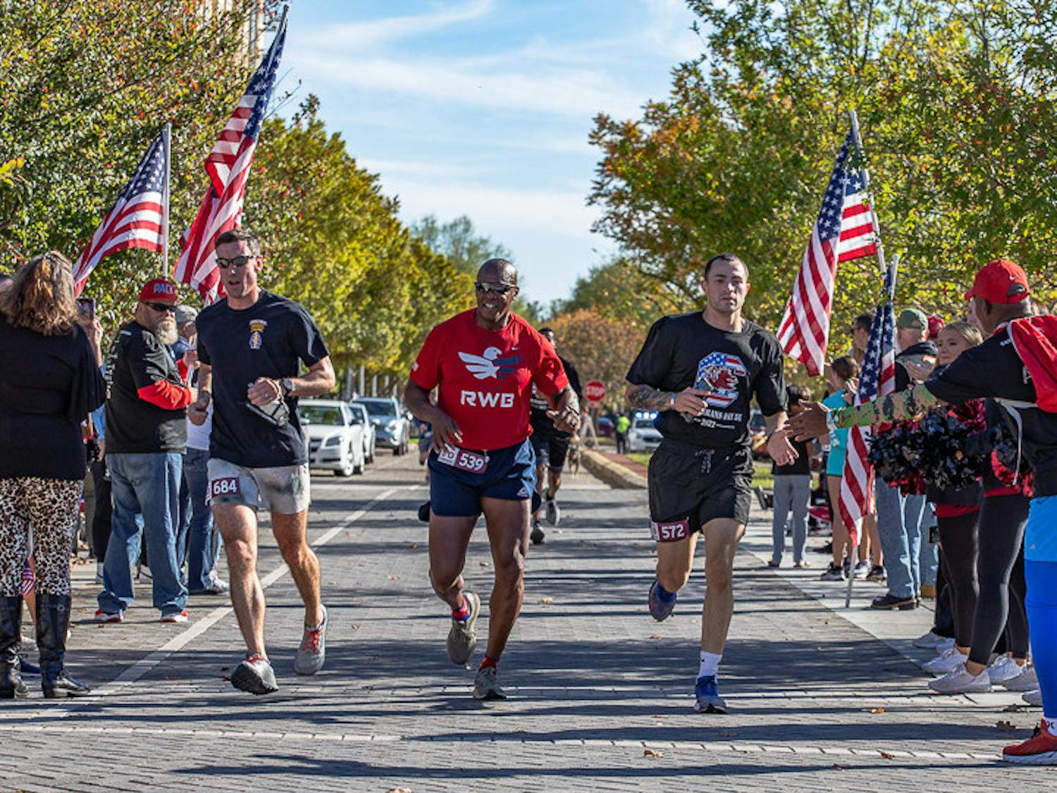Lieutenant Colonel Daniel Hayes (on left), Command Sergeant Major Philson Tavernier, (center), and Staff Sergeant Juan Vallellanes (on right), from U.S. Army Training Center Fort Jackson, run to the finish line together during the USC Veterans 5K on Nov. 13, 2022. The annual 5K honors veterans, service members, and their families. The 5K has raised over $50,000 for The Big Red Barn Retreat, which offers therapeutic programs and services for veterans, active duty service members, and first responders.