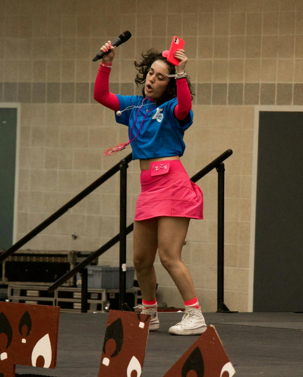 <p>Izzy Yoos pumps up the crowd before talking about how Dance Marathon helped her when she was young and struggling with health problems. Dance Marathon celebrated its 25th year raising money for the Prisma Health Children’s Hospital during their Main Event ceremony on March 25, 2023, in the Strom Thurmond Wellness and Fitness Center.&nbsp;</p>