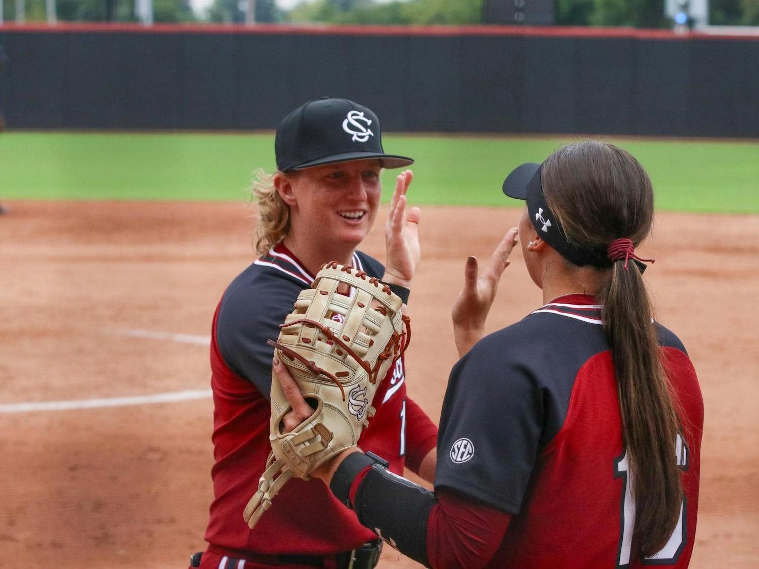 FILE — Senior catcher Jamie Mackay (left) and senior infielder Arianna Rodi (right) celebrate after an inning at Beckham Field on Sept. 28, 2025. The Gamecocks played in their Garnet & Black World Series on Oct. 28, 2025, at Beckham Field, with the Black team winning.