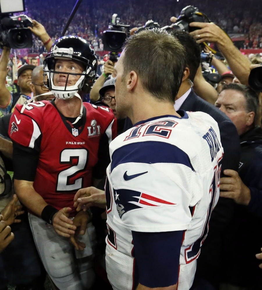 Atlanta Falcons quarterback Matt Ryan looks to the scoreboard as he congratulates New England Patriots quarterback Tom Brady on the Patriots' victory. The Atlanta Falcons lost to the New England Patriots in overtime, 34-28, in Super Bowl LI on Sunday, Feb. 5, 2017 at NRG Stadium in Houston, Texas. (Bob Andres/Atlanta Journal-Constitution/TNS)