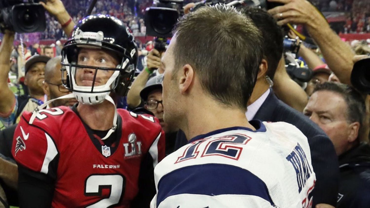 Atlanta Falcons quarterback Matt Ryan looks to the scoreboard as he congratulates New England Patriots quarterback Tom Brady on the Patriots' victory. The Atlanta Falcons lost to the New England Patriots in overtime, 34-28, in Super Bowl LI on Sunday, Feb. 5, 2017 at NRG Stadium in Houston, Texas. (Bob Andres/Atlanta Journal-Constitution/TNS)