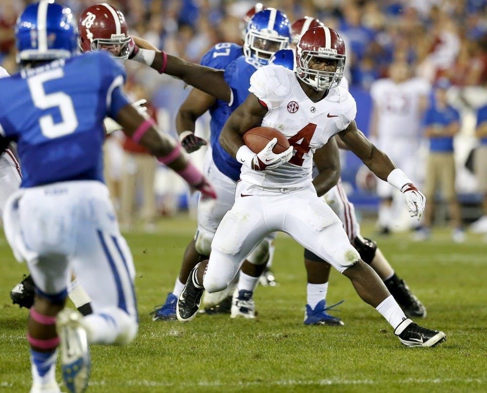 Alabama Crimson Tide running back T.J. Yeldon (4) runs away from Kentucky's defense for a 24-yard touchdown on Saturday, October 12, 2013, in Lexington, Kentucky. (Mark Cornelison/Lexington Herald/MCT)