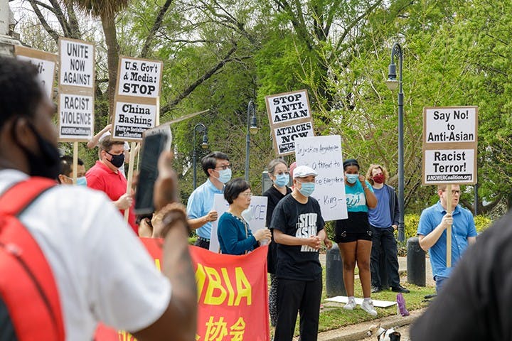  A group holds signs in protest of Asian hate that is happening within Asian communities.
