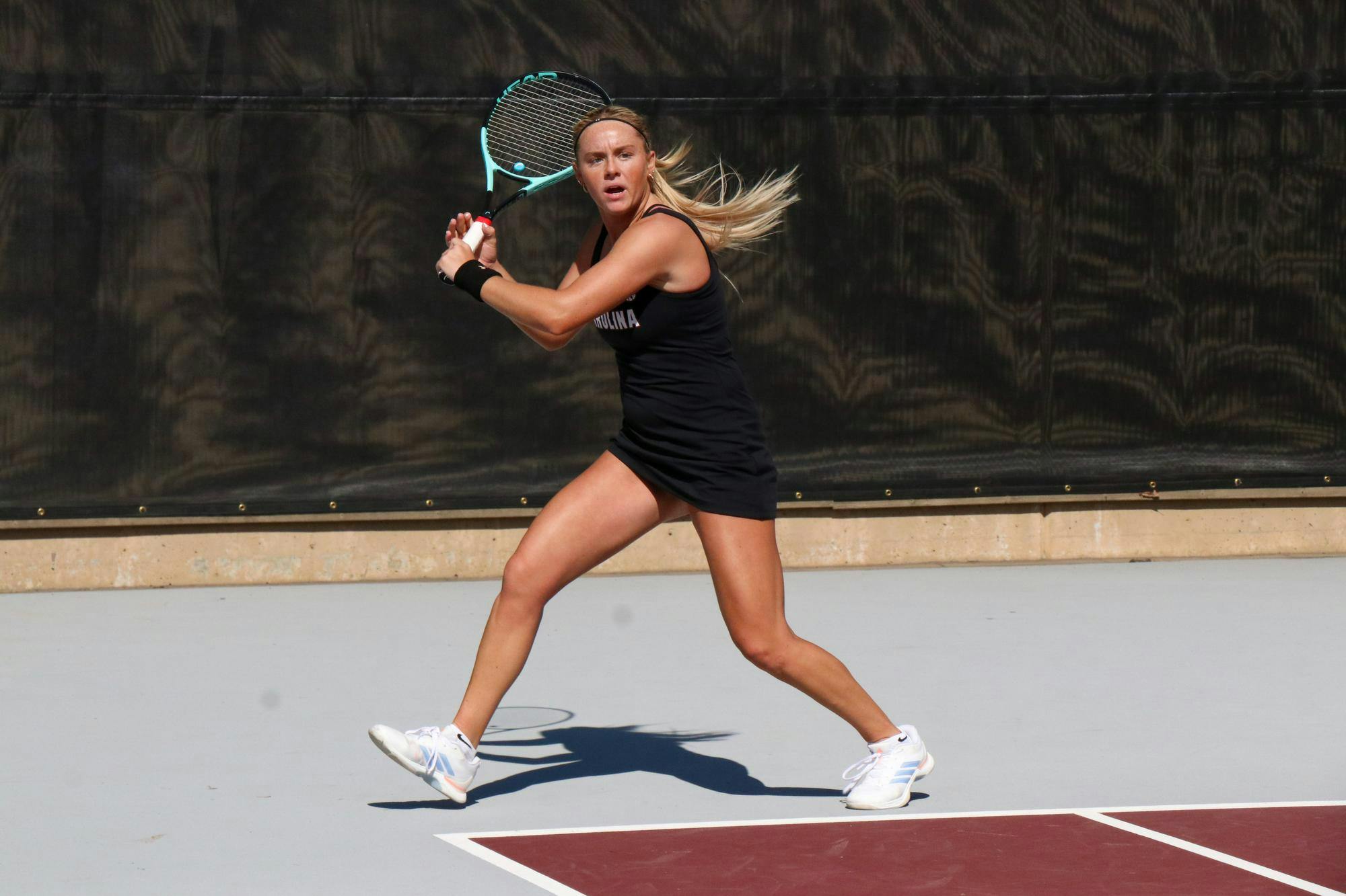 Freshman Jane Dunyon winds up to return a hit in her singles match against Yelyzaveta Chainykova of the University of North Carolina at Charlotte at the Carolina Tennis Center on Feb. 14, 2026. Dunyon and Chainykova were tied after two matches, and the third match went unfinished.