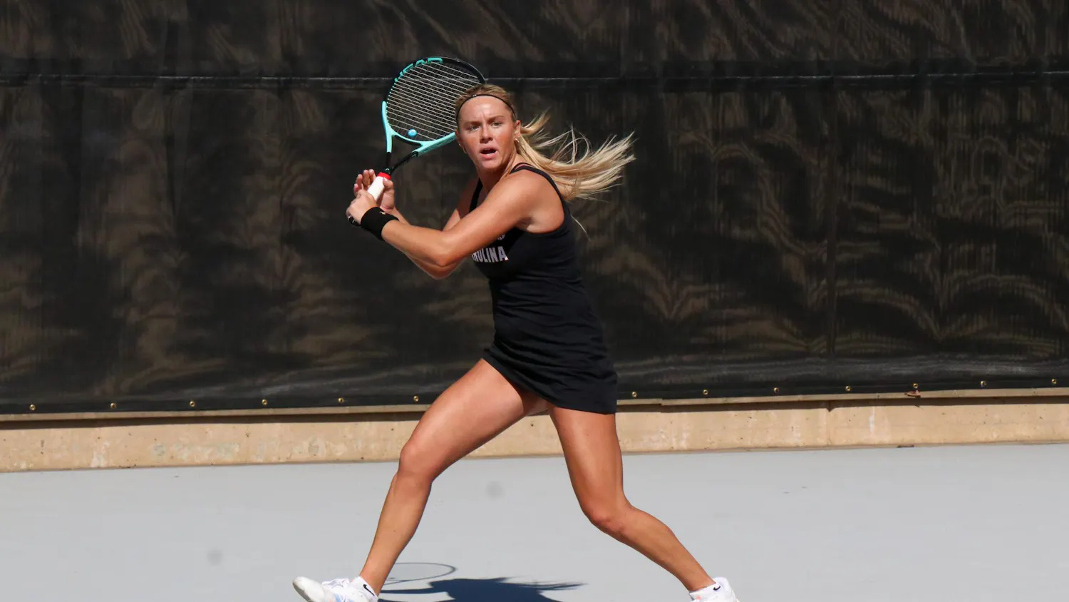 Freshman Jane Dunyon winds up to return a hit in her singles match against Yelyzaveta Chainykova of the University of North Carolina at Charlotte at the Carolina Tennis Center on Feb. 14, 2026. Dunyon and Chainykova were tied after two matches, and the third match went unfinished.