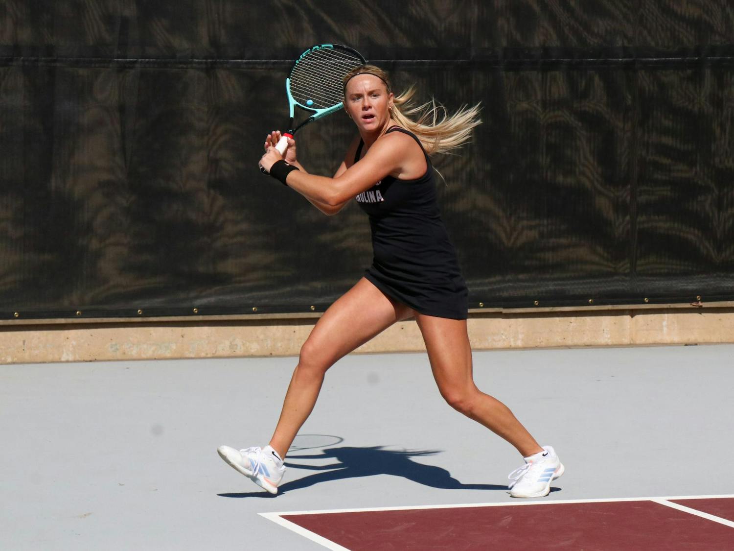 Freshman Jane Dunyon winds up to return a hit in her singles match against Yelyzaveta Chainykova of the University of North Carolina at Charlotte at the Carolina Tennis Center on Feb. 14, 2026. Dunyon and Chainykova were tied after two matches, and the third match went unfinished.