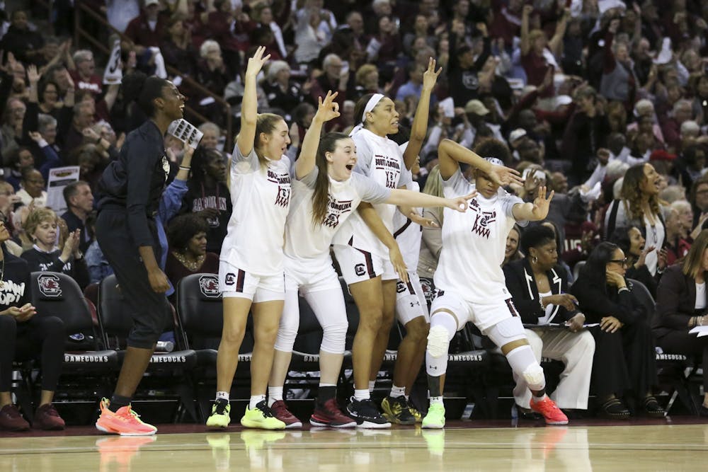 <p>South Carolina’s bench celebrates after one of its players scored a 3-point shot during the second half. The Gamecocks had multiple 3-point shots to start the second half.</p>