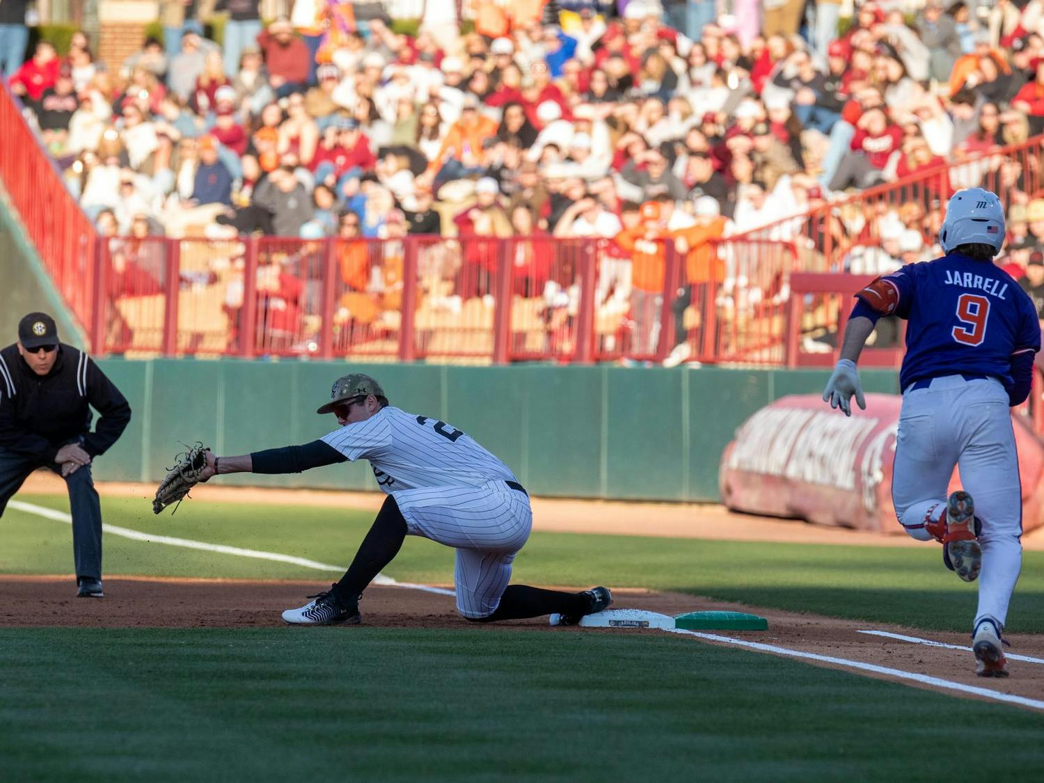 Junior infielder Ethan Petry catches a throw at first base on March 2, 2025 as a Clemson runner approaches first base. Petry started the game with 63 putouts on the season.