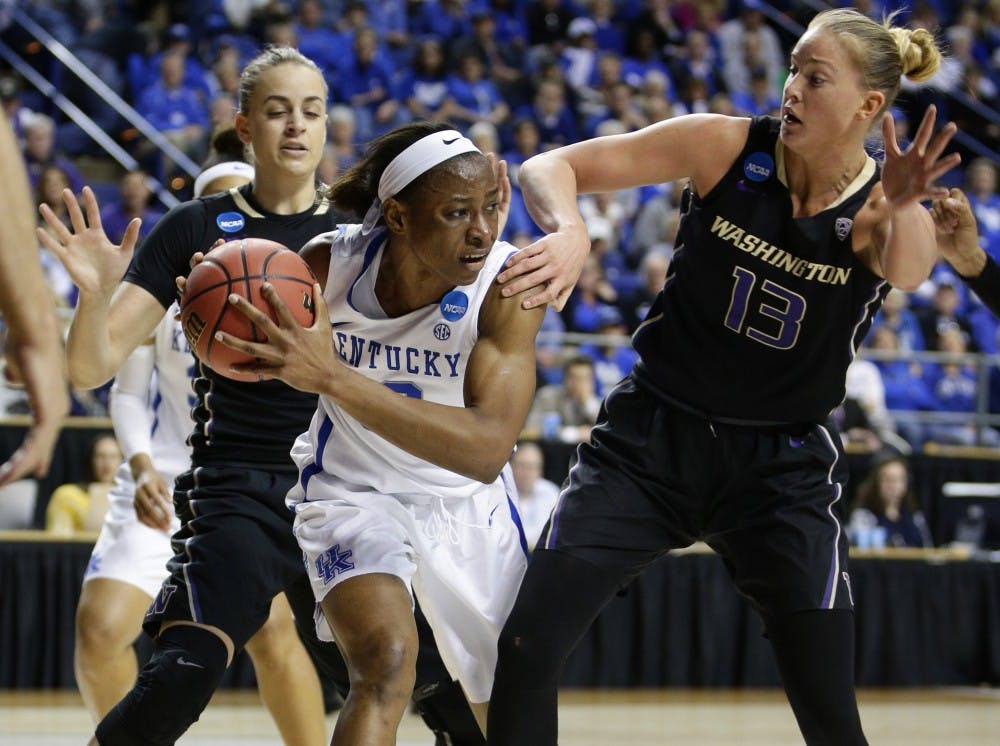 Kentucky's Evelyn Akhator, middle, looks to pass after grabbing a rebound in front of Washington's Katie Collier, right, in the third round of the NCAA Tournament on Friday, March 25, 2016, at Rupp Arena in Lexington, Ky. (Mark Cornelison/Lexington Herald-Leader/TNS)