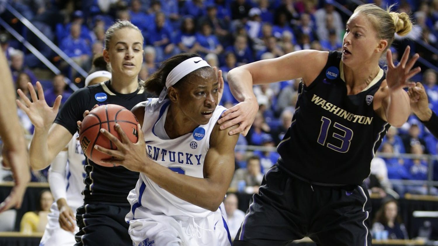 Kentucky's Evelyn Akhator, middle, looks to pass after grabbing a rebound in front of Washington's Katie Collier, right, in the third round of the NCAA Tournament on Friday, March 25, 2016, at Rupp Arena in Lexington, Ky. (Mark Cornelison/Lexington Herald-Leader/TNS)