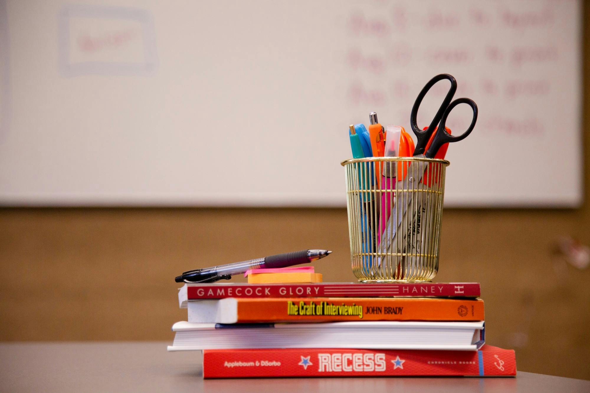 A stack of school supplies with a whiteboard in the background taken on July 5, 2022.&nbsp;