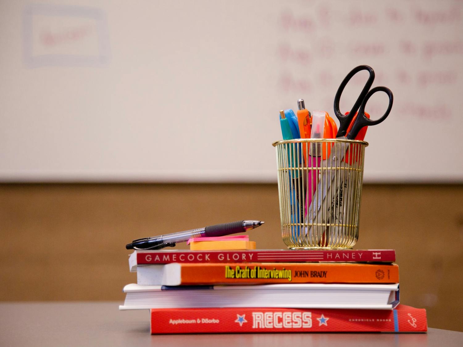 A stack of school supplies with a whiteboard in the background taken on July 5, 2022.&nbsp;