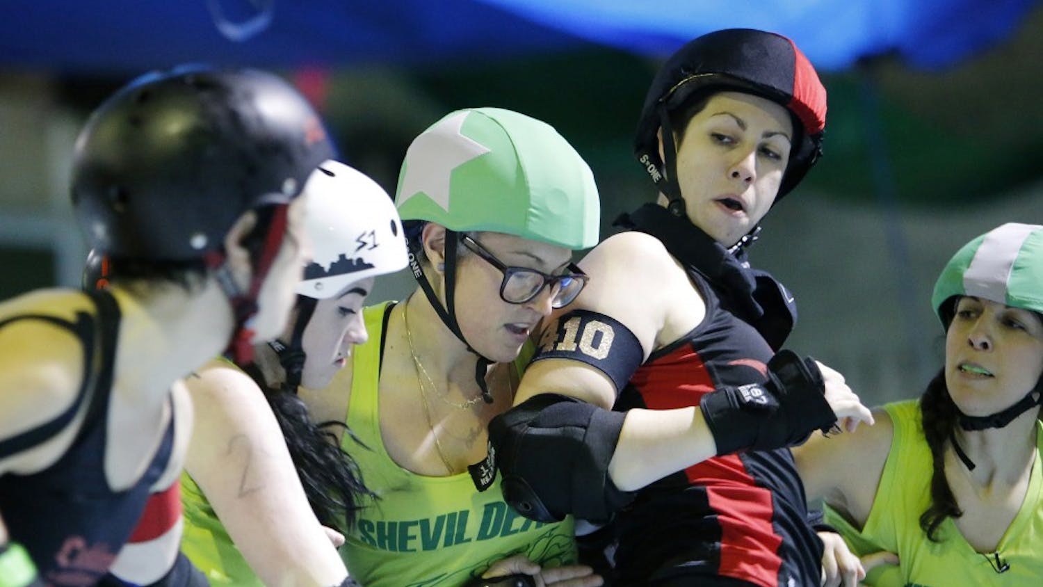 Playing for the San Francisco ShEvil Dead, skater Veronica De La Rosa, known as "Sterling Archer," center, battles for position against the Oakland Outlaws' blockers during scrimmage night on Thursday, Feb. 9, 2017 in Oakland, Calif. Bay Area Derby (BAD) is home of the Berkeley Resistance, Richmond Wrecking Belles, Oakland Outlaws and San Francisco ShEvil Dead and is a full contact women's flat track roller derby league in Oakland. (Josie Lepe/Bay Area News Group/TNS)