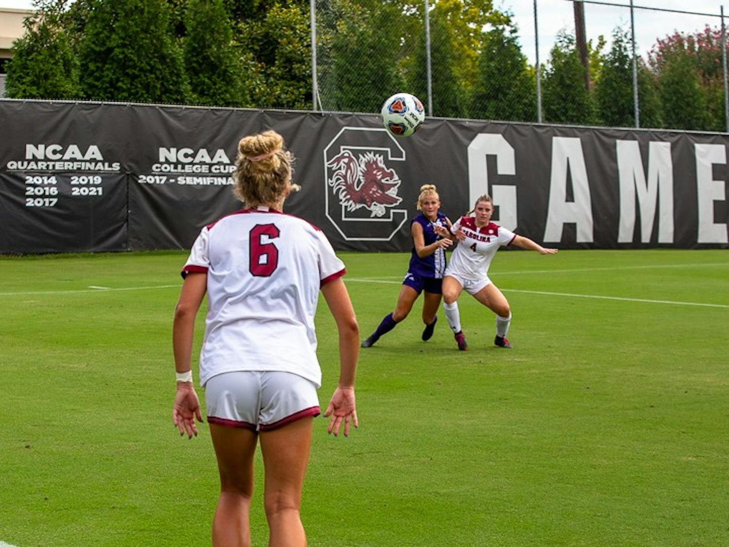 Senior Defender Camryn Dixon throws in the ball to Freshman Forward Shae O'Rourke during the team's game against East Carolina on August 21, 2022.