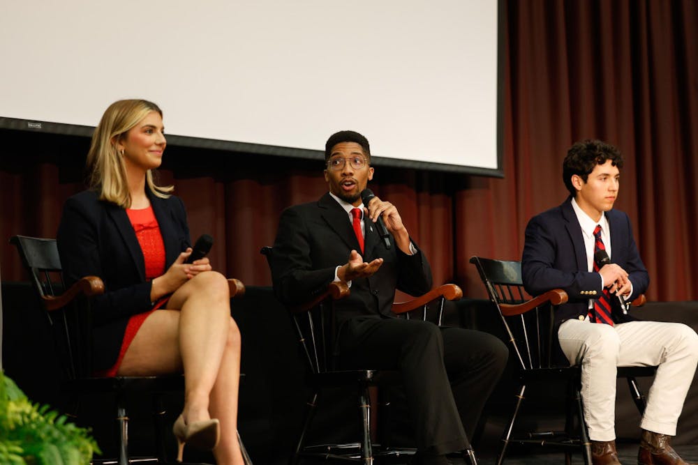 <p>Student Body President candidates Courtney Tkacs, Bradley Gittens and David Henao sit together onstage during the Student Government candidate debate in the Russell House Ballroom on Feb. 19, 2025. All three candidates talked about their plans to improve certain aspects of student life at USC if elected.</p>