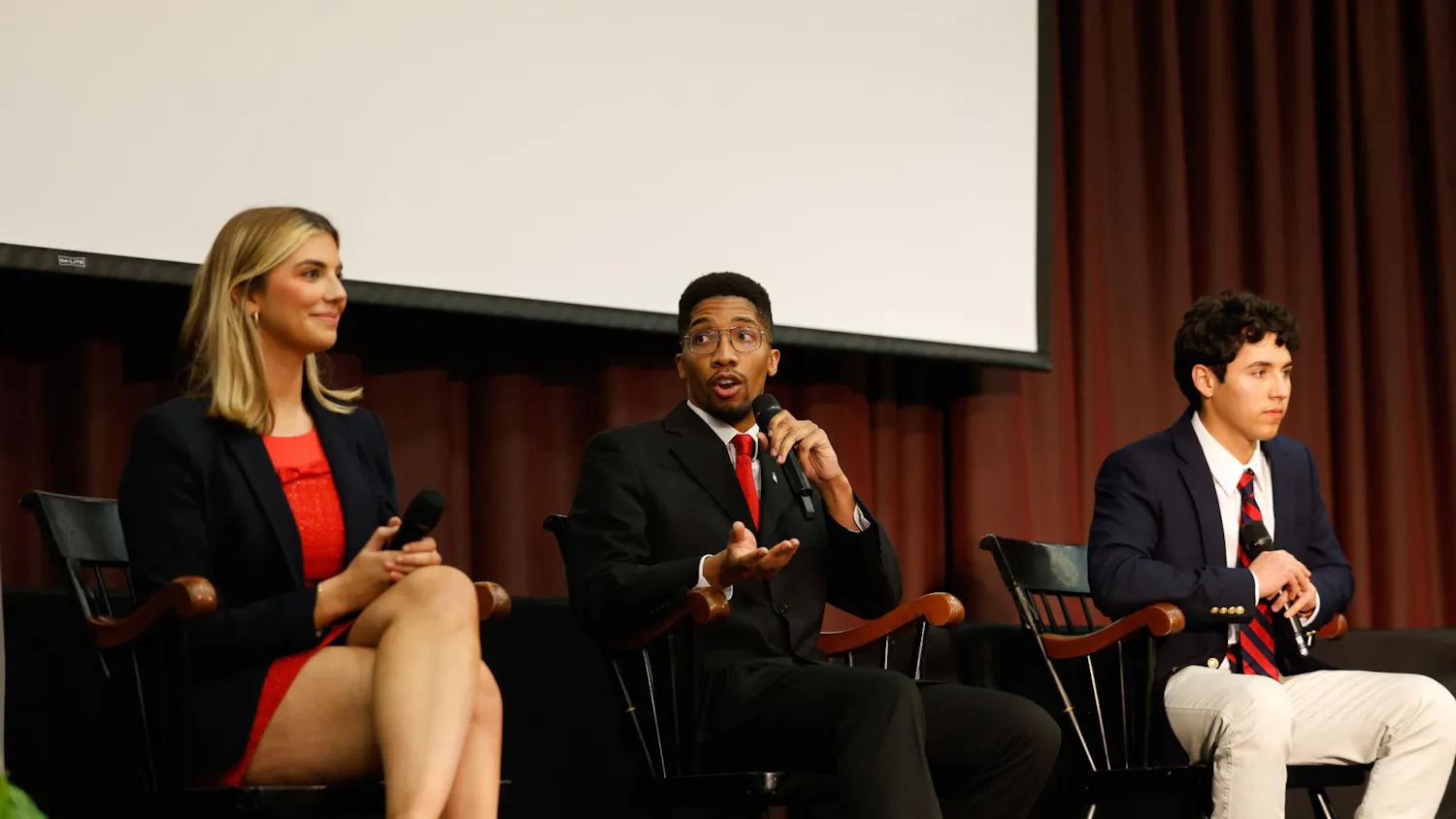 Student Body President candidates Courtney Tkacs, Bradley Gittens and David Henao sit together onstage during the Student Government candidate debate in the Russell House Ballroom on Feb. 19, 2025. All three candidates talked about their plans to improve certain aspects of student life at USC if elected.