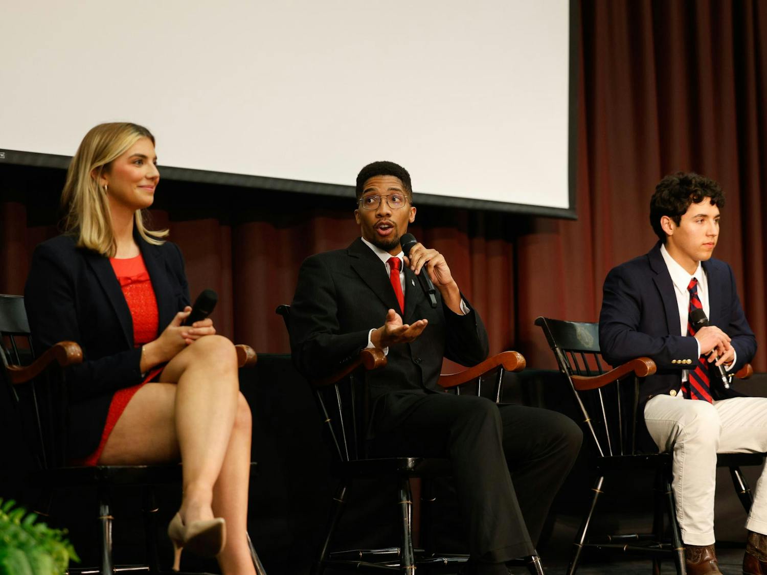 Student Body President candidates Courtney Tkacs, Bradley Gittens and David Henao sit together onstage during the Student Government candidate debate in the Russell House Ballroom on Feb. 19, 2025. All three candidates talked about their plans to improve certain aspects of student life at USC if elected.