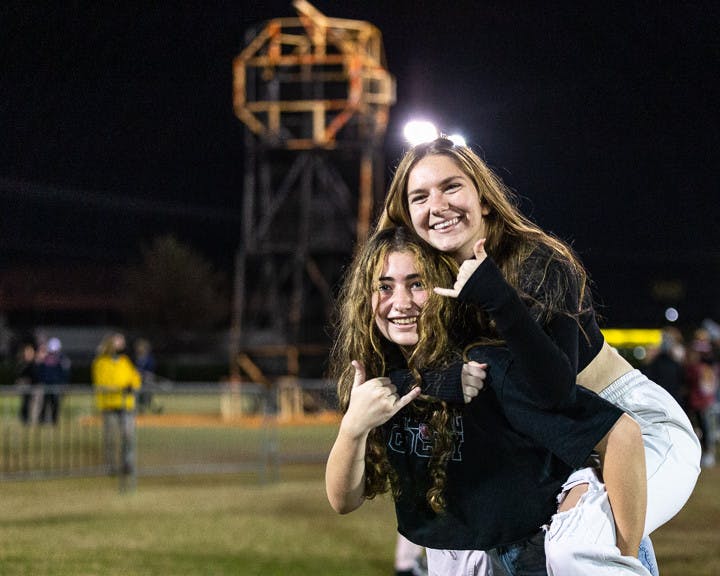 Freshman biomedical engineering students Gabby Cordell (on left) and Chloe Quinton (on right) pose in front of the burned-down Clemson Tiger statue on Nov. 21, 2022. USC hosts this event annually during the week leading up to the South Carolina-Clemson football rival match the following Saturday. This year Clemson is hosting the game at their field, "Death Valley" on Nov. 26, 2022.