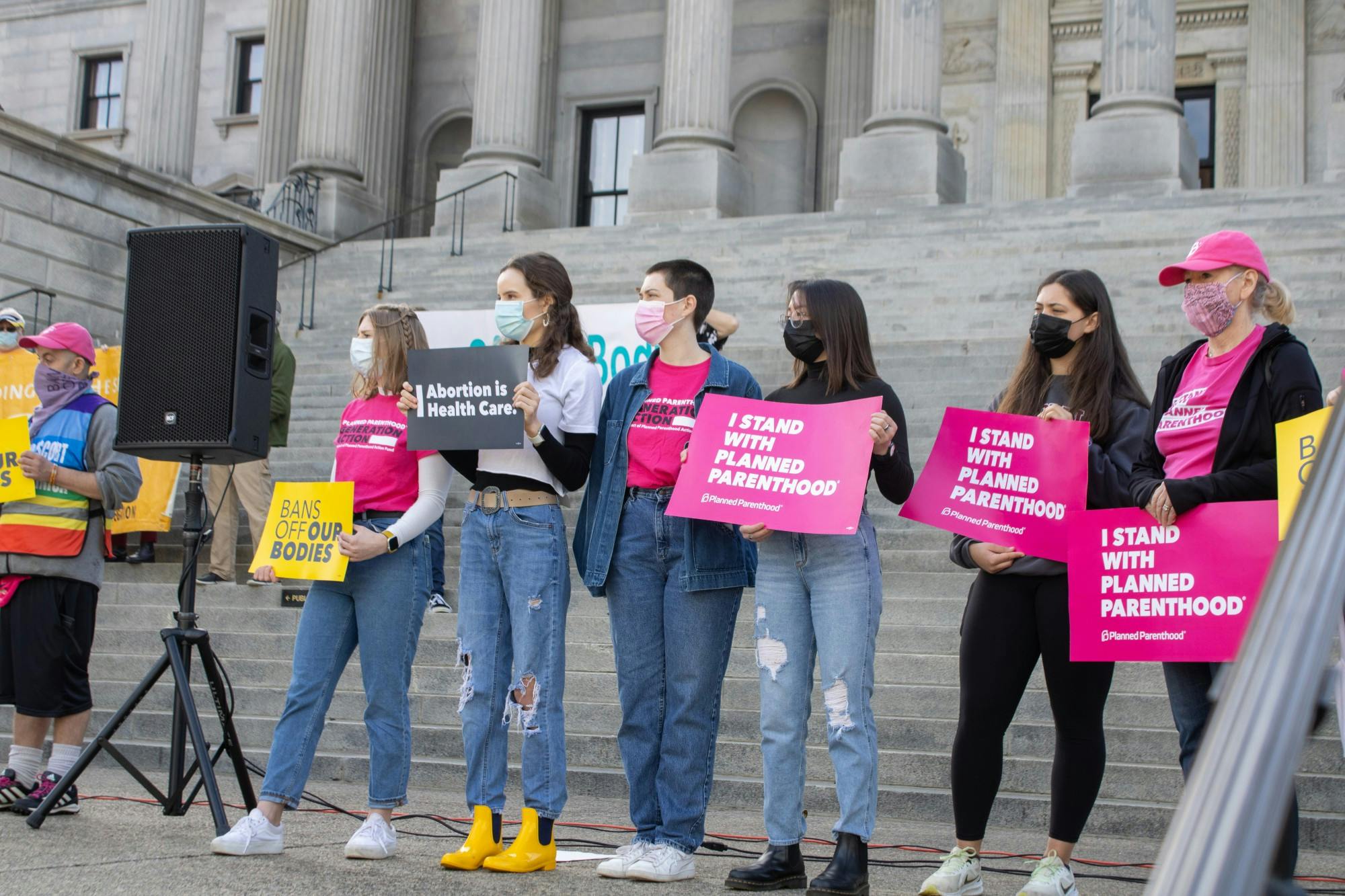 Protestors stand on the steps of the South Carolina capitol building on Feb. 17, 2022. The protestors were part of a demonstration against anti-abortion bills.