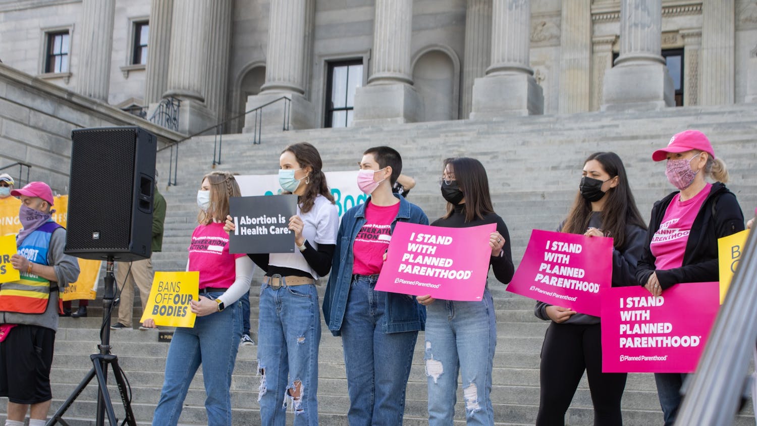 Protestors stand on the steps of the South Carolina capitol building on Feb. 17, 2022. The protestors were part of a demonstration against anti-abortion bills.