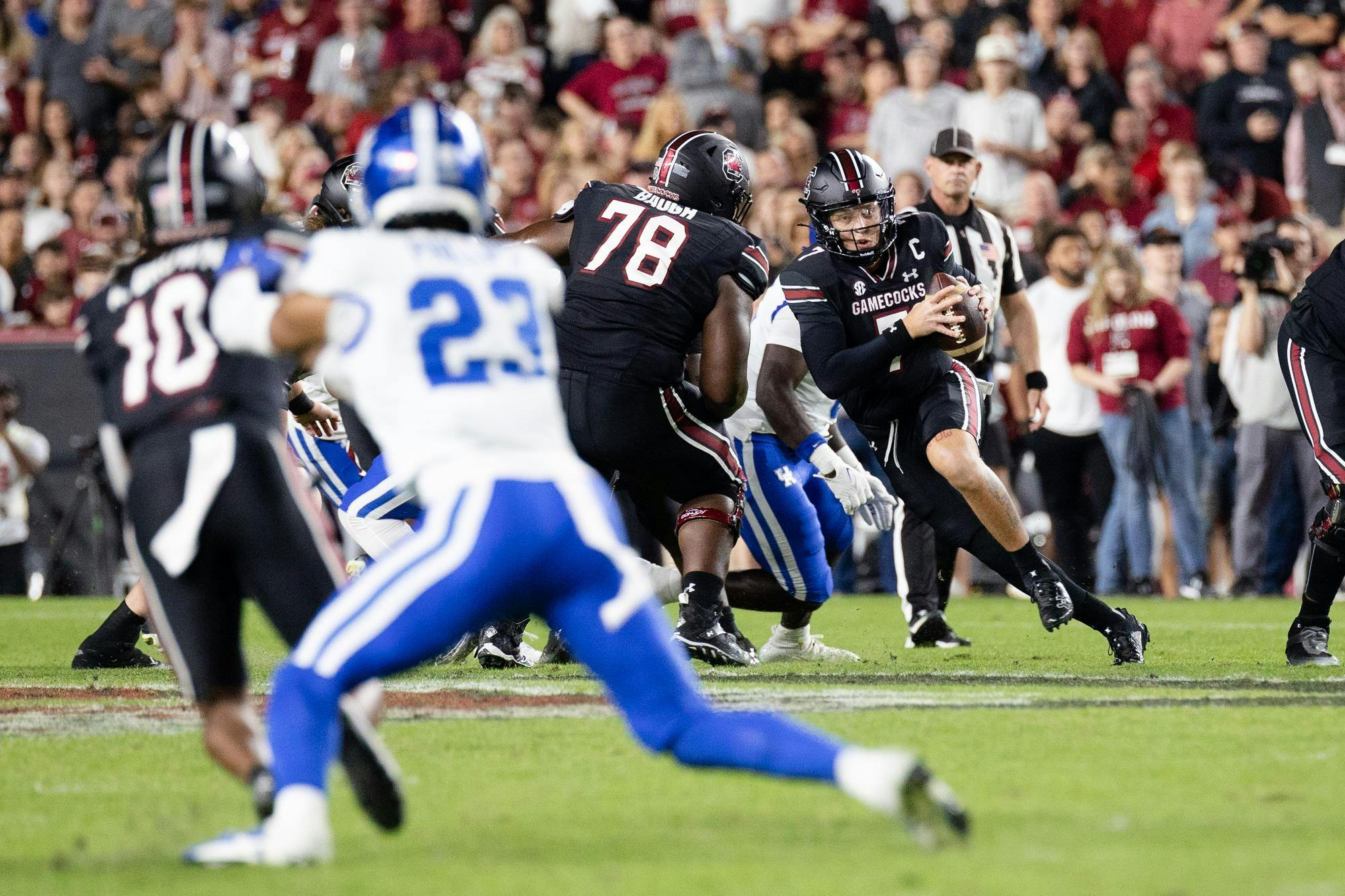 Redshirt senior quarterback Spencer Rattler weaves through offensive and defensive players during the game against Kentucky on Nov. 18, 2023. The Gamecocks defeated the Wildcats 17-14 and now only need to win one more game to be bowl eligible.
