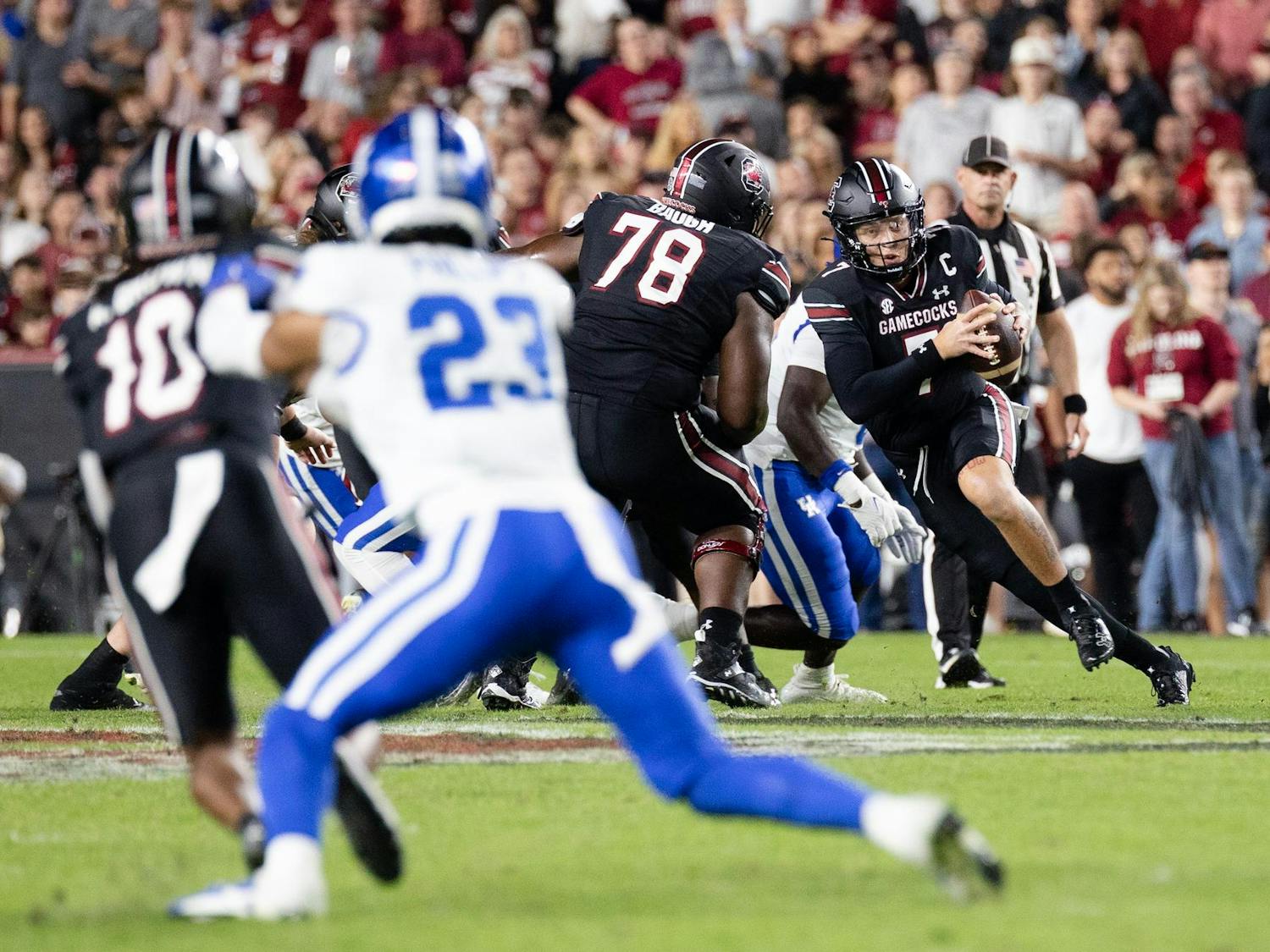 Redshirt senior quarterback Spencer Rattler weaves through offensive and defensive players during the game against Kentucky on Nov. 18, 2023. The Gamecocks defeated the Wildcats 17-14 and now only need to win one more game to be bowl eligible.