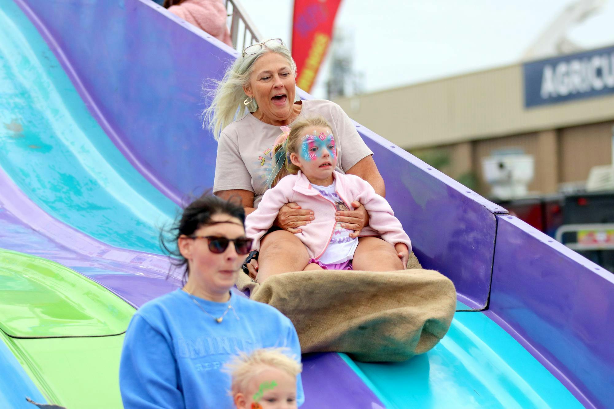 Karen Pressley rides down the Fun Slide with her granddaughter, Ellie, at the South Carolina State Fair on Oct. 10, 2025. Pressley traveled from Greenwood, South Carolina, to visit the fair in Columbia.